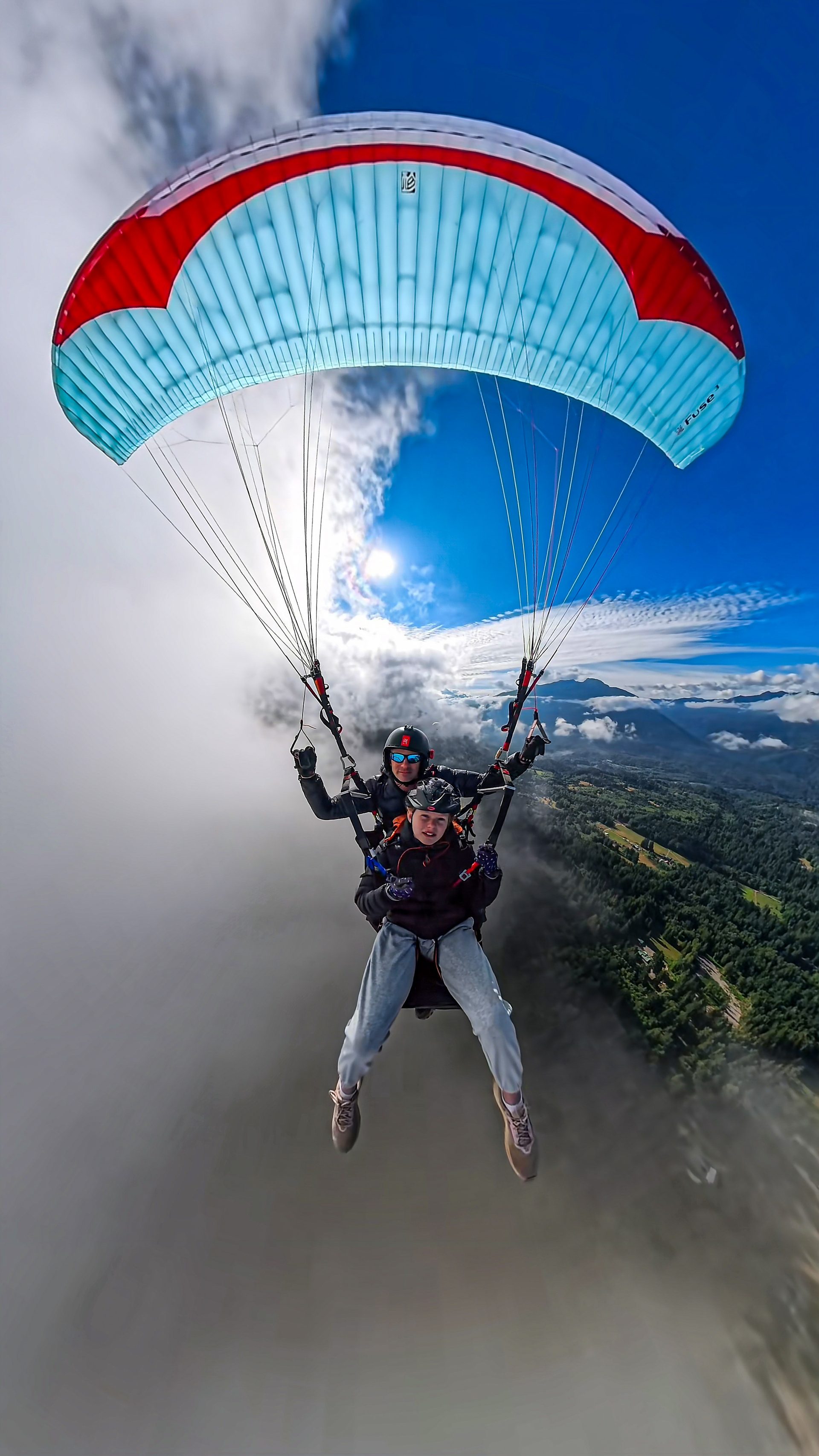 Tandem passenger smiling mid-flight